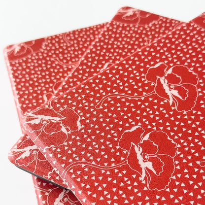 Red fabric with white floral patterns on a white background
